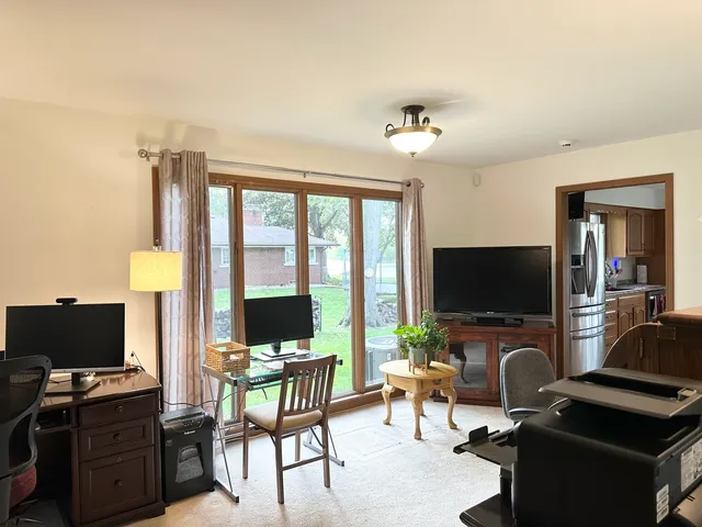 a view of a livingroom with workspace and a window
