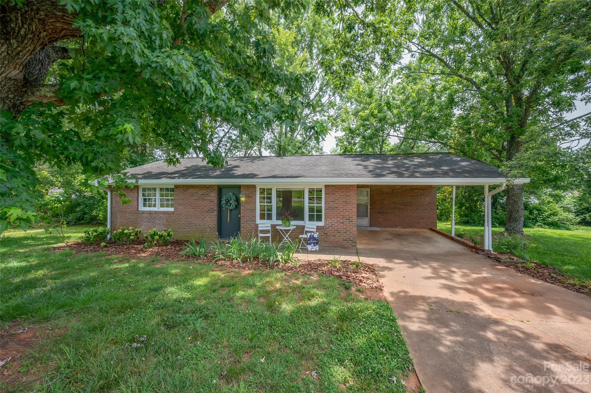 1034 Old Stonecutter Road Rutherfordton, NC 28139 - Photo 1 of 27 a front view of a house with a garden