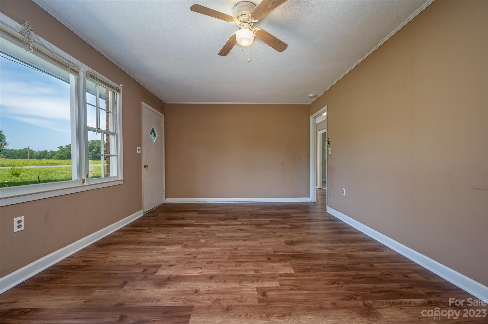 1034 Old Stonecutter Road Rutherfordton, NC 28139 - Photo 11 of 27 a view of an empty room with window and wooden floor