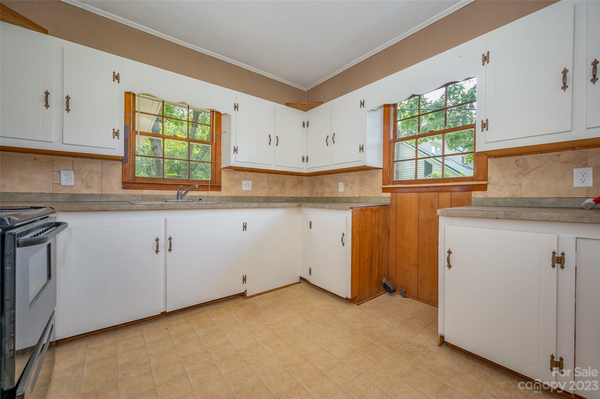 1034 Old Stonecutter Road Rutherfordton, NC 28139 - Photo 13 of 27 a kitchen with granite countertop white cabinets white appliances a sink and a window
