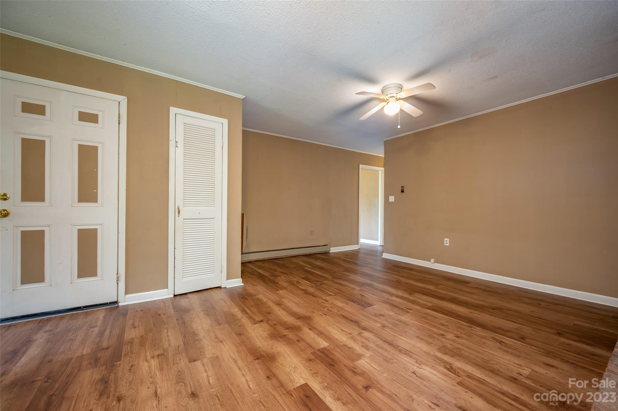 1034 Old Stonecutter Road Rutherfordton, NC 28139 - Photo 15 of 27 a view of an empty room with chandelier fan and wooden floor
