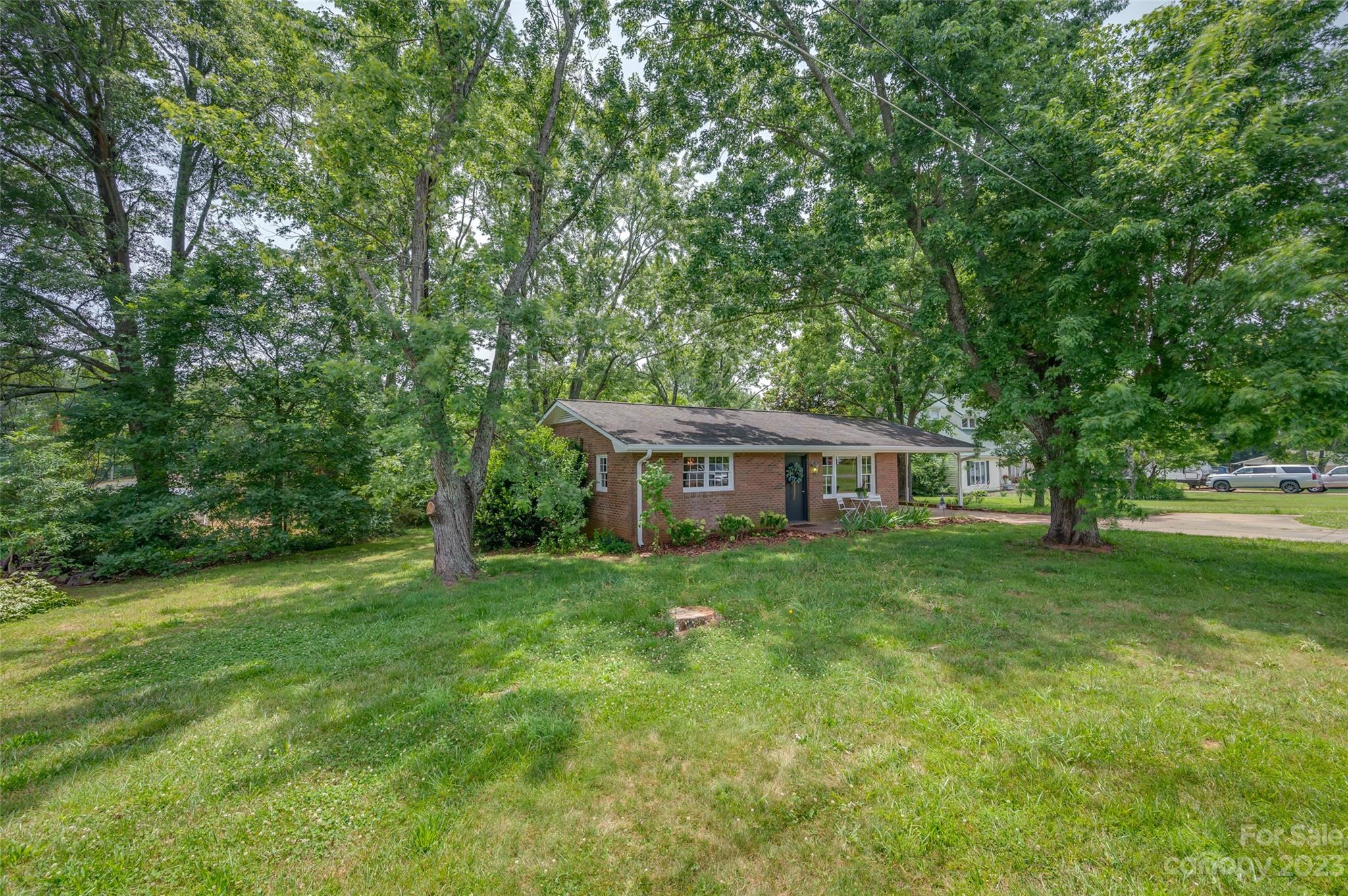 1034 Old Stonecutter Road Rutherfordton, NC 28139 - Photo 25 of 27 a view of a house with a big yard potted plants and large trees