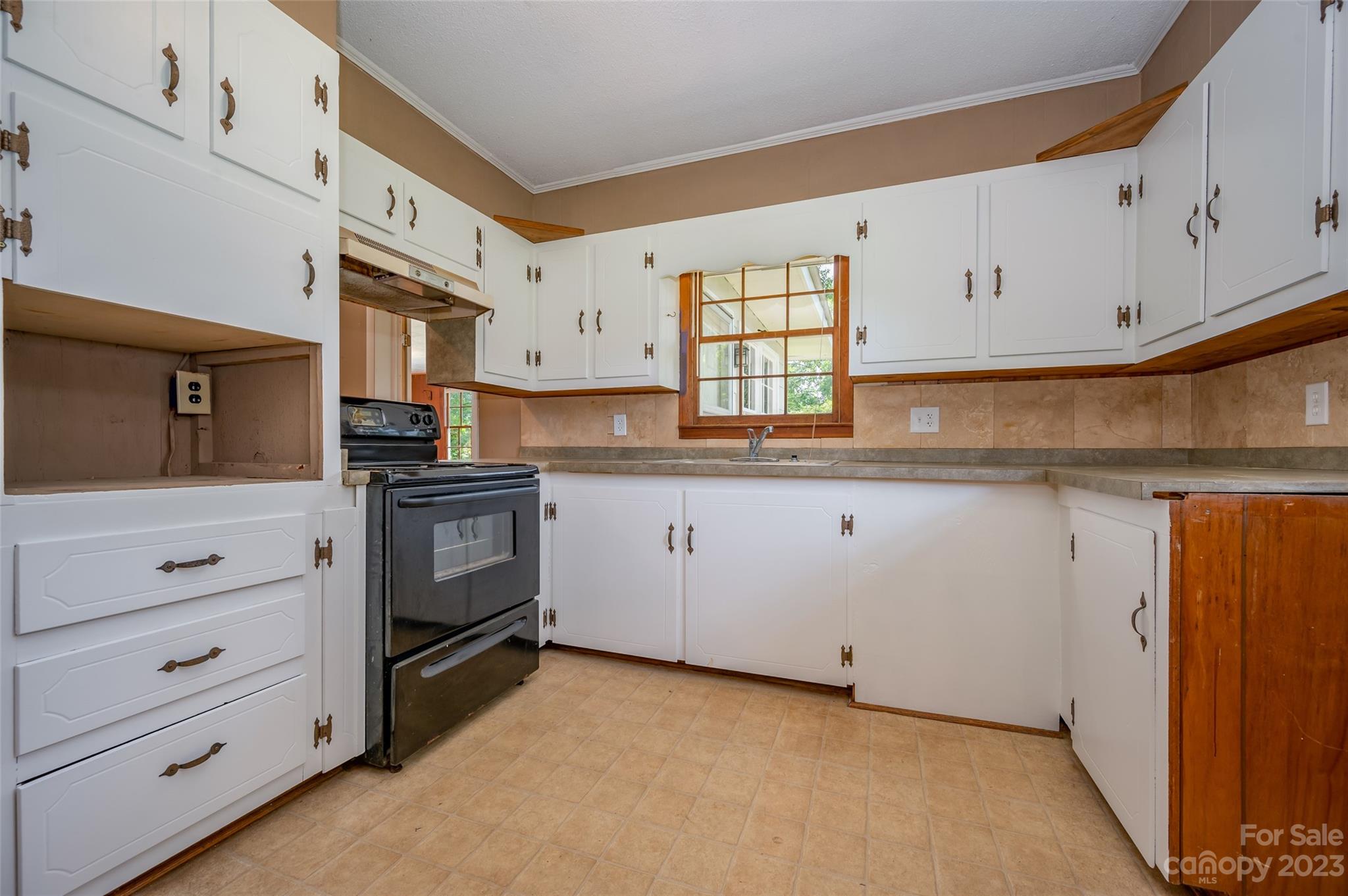 1034 Old Stonecutter Road Rutherfordton, NC 28139 - Photo 6 of 27 a kitchen with granite countertop white cabinets white stainless steel appliances and sink
