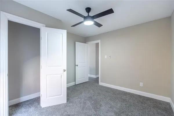 an empty room with ceiling fan