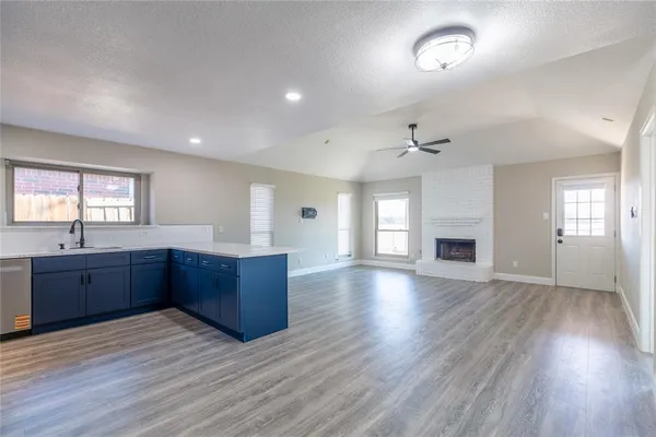 an empty room with wooden floor and window