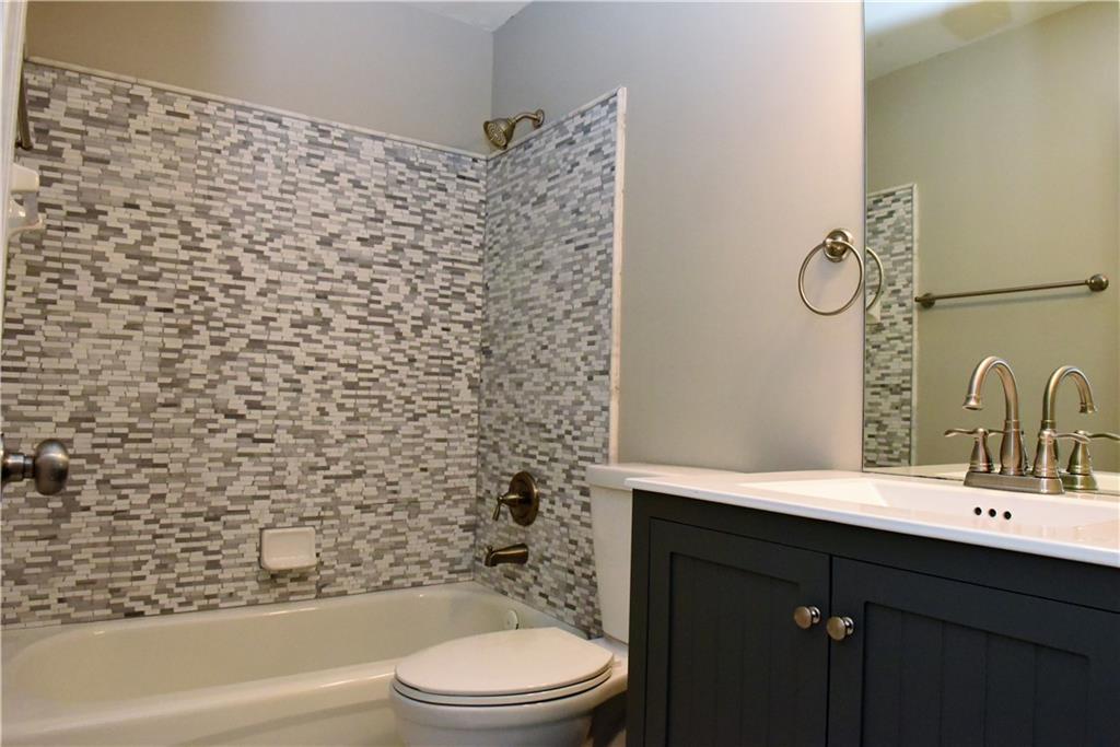 12720 Morningpark Circle Alpharetta, GA 30004 - Photo 16 of 31 a bathroom with a sink a toilet and shower