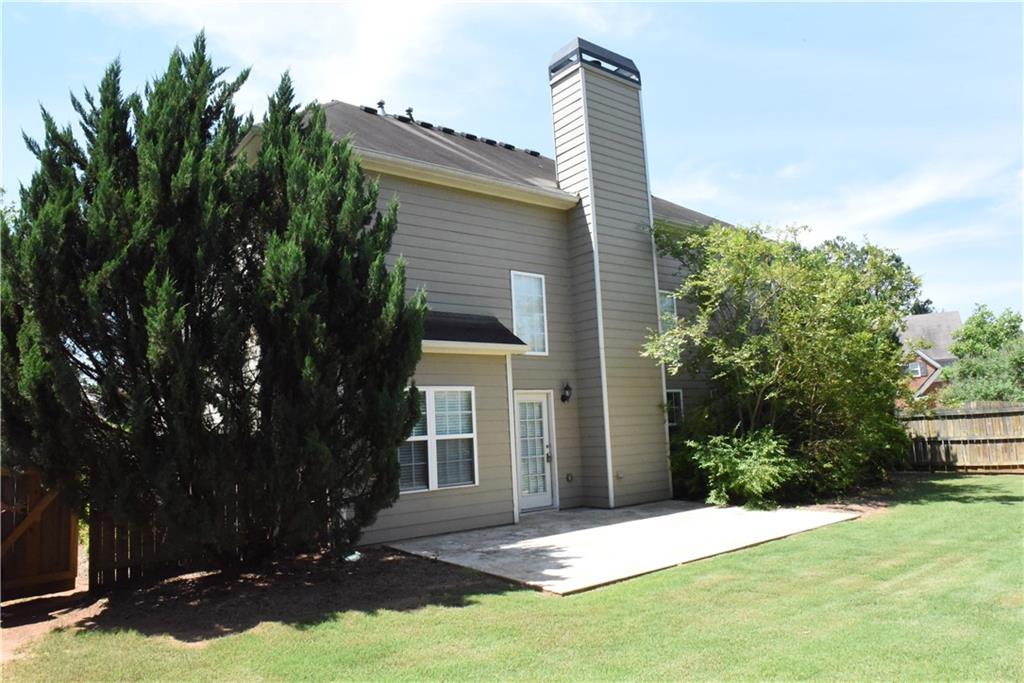 12720 Morningpark Circle Alpharetta, GA 30004 - Photo 19 of 31 a front view of a house with yard and green space