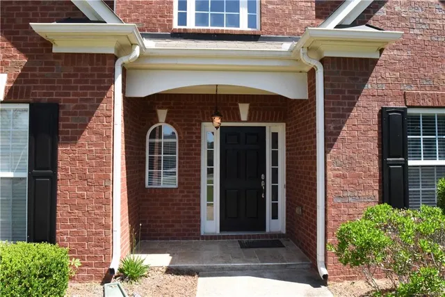 a front view of a house with garden