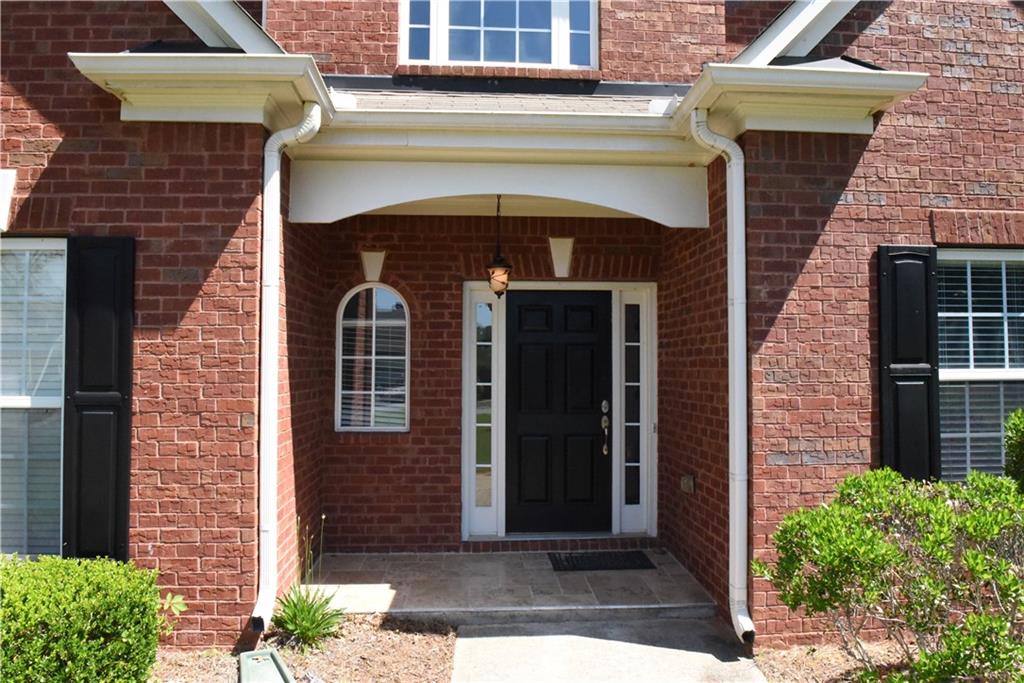 12720 Morningpark Circle Alpharetta, GA 30004 - Photo 2 of 31 a front view of a house with garden