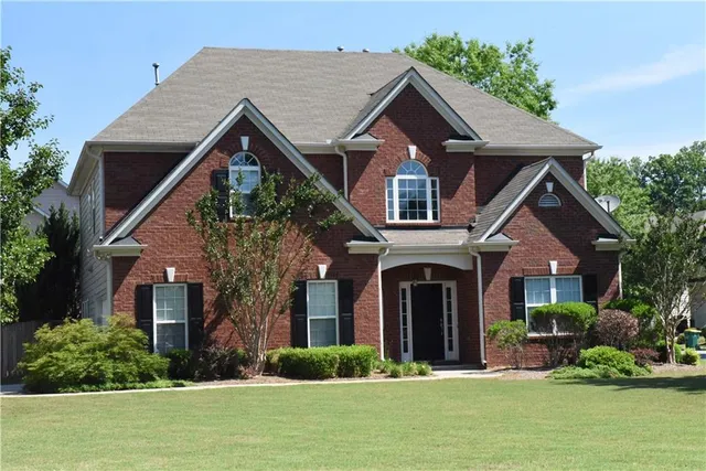 a front view of a house with a yard