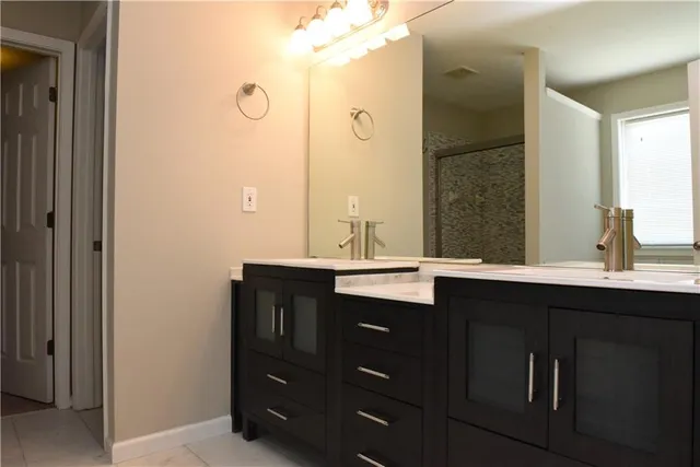 a bathroom with a double vanity sink and mirror