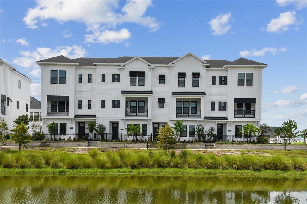 a view of house with swimming pool and a yard