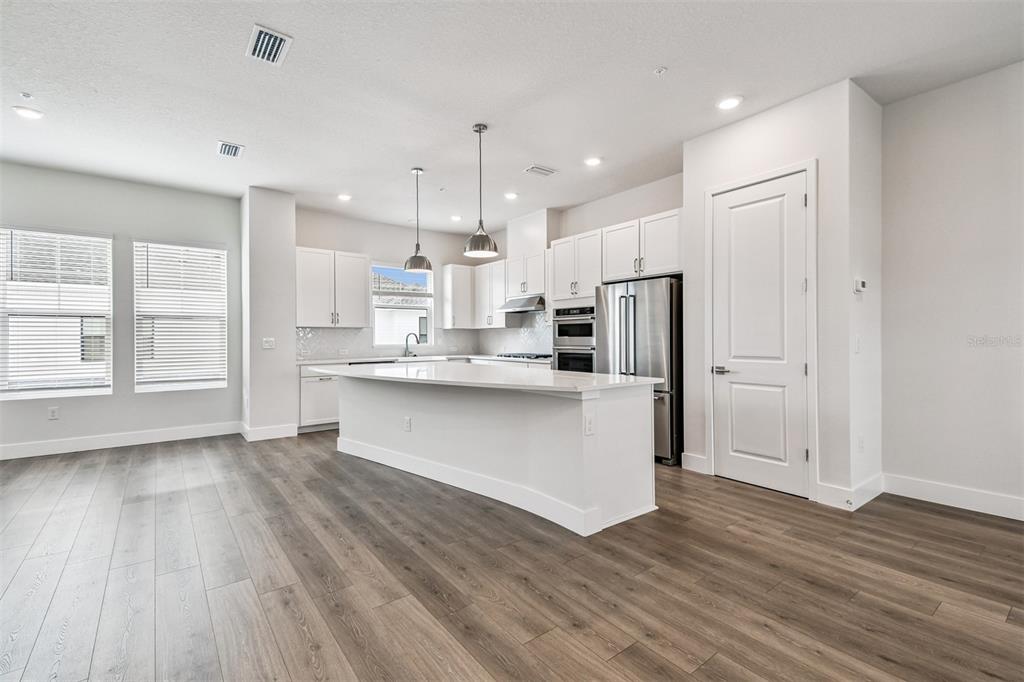 7204 Sutton Lane Sarasota, FL 34240 - Photo 11 of 47 a kitchen with stainless steel appliances sink refrigerator and cabinets