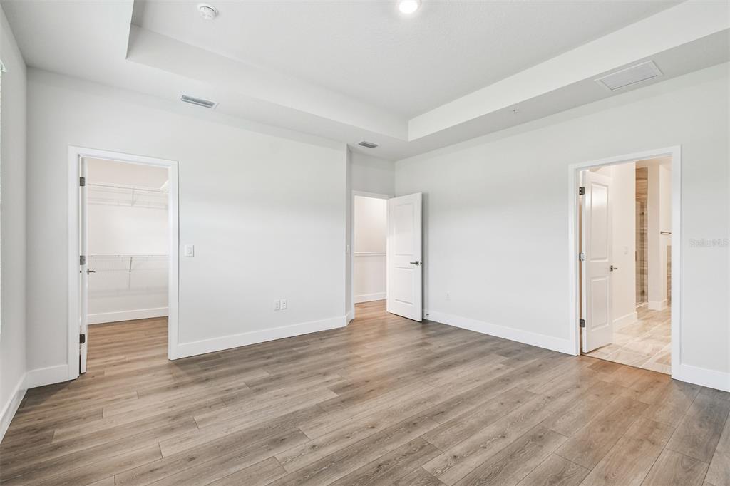 7204 Sutton Lane Sarasota, FL 34240 - Photo 24 of 47 a view of an empty room with wooden floor and a window