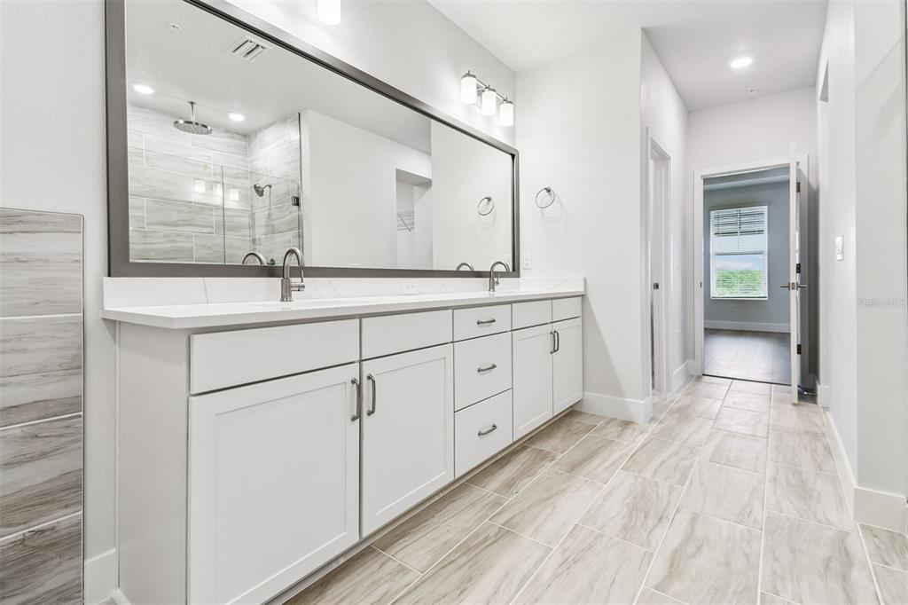 7204 Sutton Lane Sarasota, FL 34240 - Photo 27 of 47 a bathroom with a double vanity sink and mirror