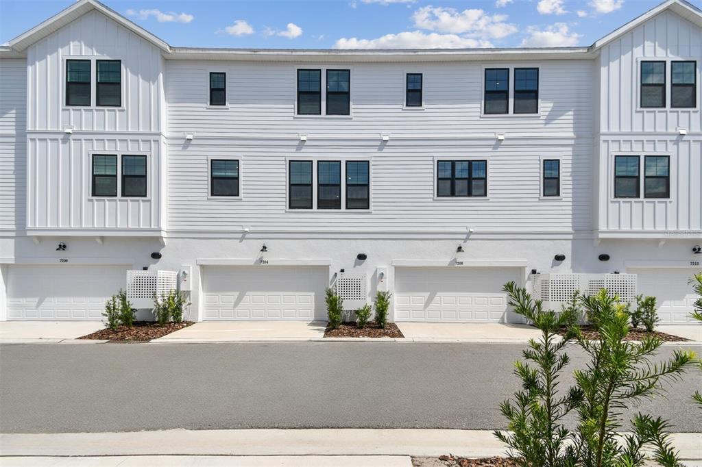 7204 Sutton Lane Sarasota, FL 34240 - Photo 43 of 47 a front view of a house with a yard and a outdoor space