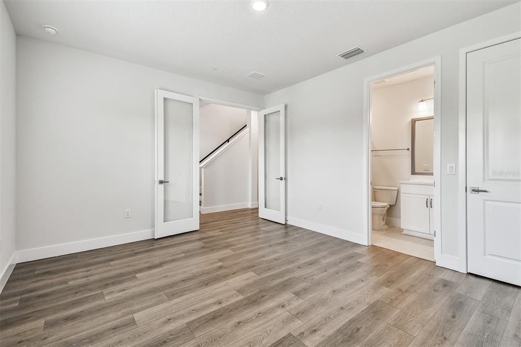 7204 Sutton Lane Sarasota, FL 34240 - Photo 8 of 47 a view of an empty room with wooden floor
