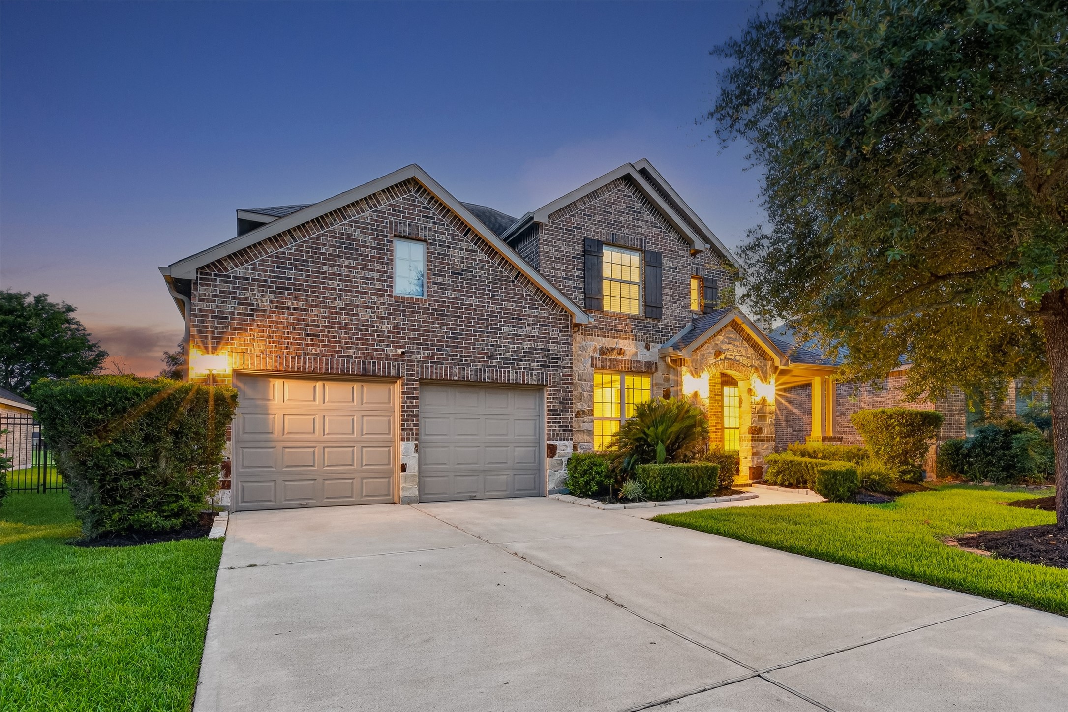 7930 Summer Night Lane Rosenberg, TX 77469 - Photo 4 of 48 Beautiful brick and stone exterior with a spacious driveway, manicured landscaping, and excellent curb appeal.