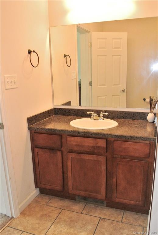 335 Upper Thomas Branch Road Marshall, NC 28753 - Photo 12 of 22 a bathroom with a granite countertop sink and a mirror