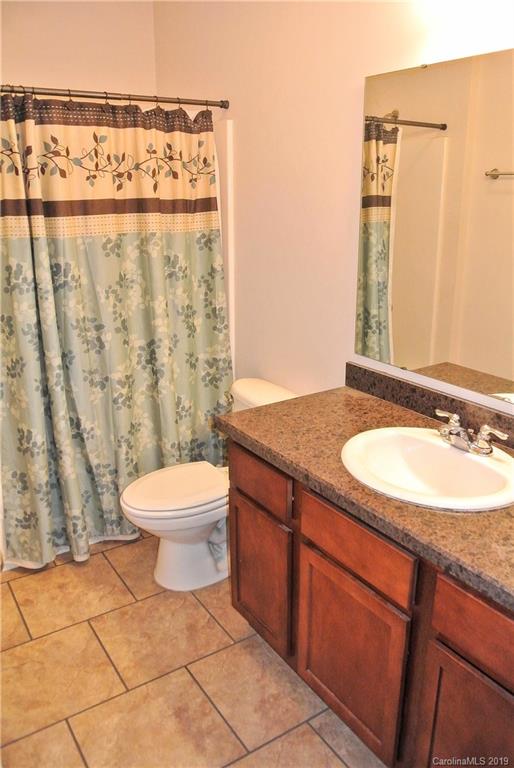 335 Upper Thomas Branch Road Marshall, NC 28753 - Photo 16 of 22 a bathroom with a granite countertop sink and a mirror