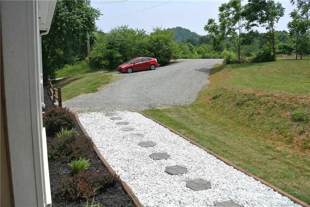 335 Upper Thomas Branch Road Marshall, NC 28753 - Photo 19 of 22 a view of a backyard with a garden