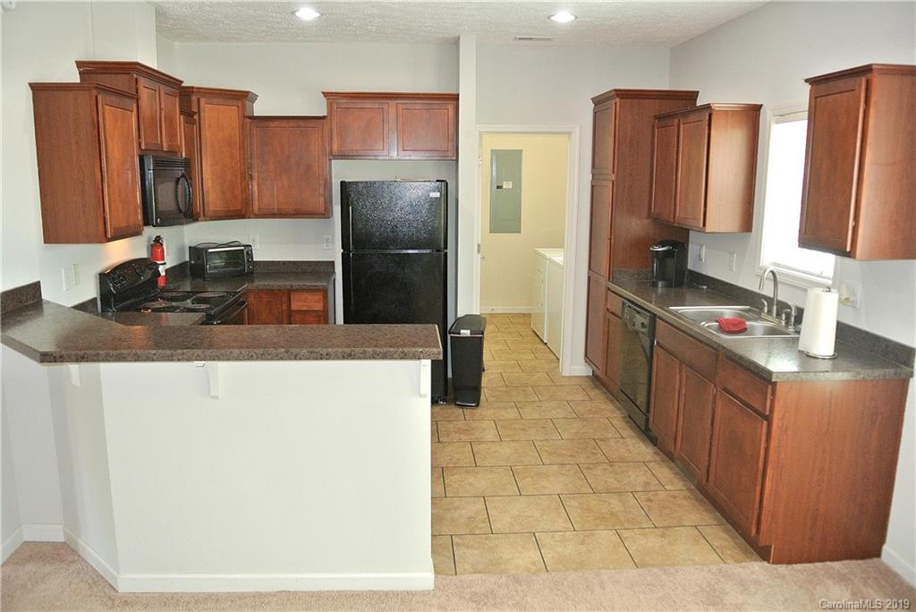 335 Upper Thomas Branch Road Marshall, NC 28753 - Photo 3 of 22 a kitchen with stainless steel appliances a refrigerator and a counter space