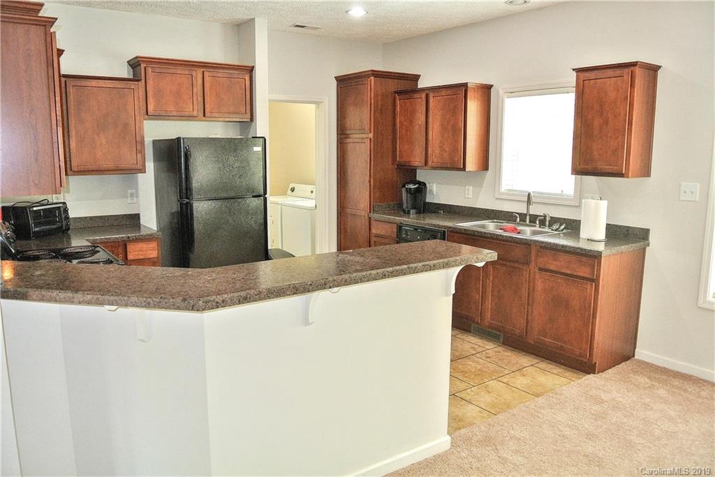 335 Upper Thomas Branch Road Marshall, NC 28753 - Photo 5 of 22 a kitchen with stainless steel appliances granite countertop a sink a stove a refrigerator a washer and dryer