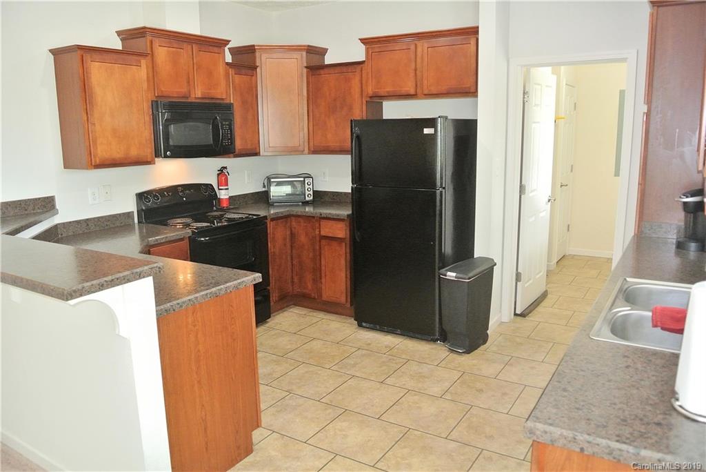 335 Upper Thomas Branch Road Marshall, NC 28753 - Photo 6 of 22 a kitchen with stainless steel appliances granite countertop a refrigerator and a stove