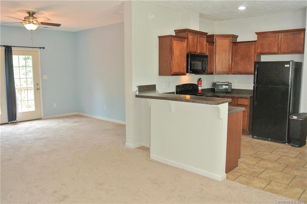 335 Upper Thomas Branch Road Marshall, NC 28753 - Photo 8 of 22 a kitchen with stainless steel appliances granite countertop a refrigerator a stove top oven a sink and dishwasher