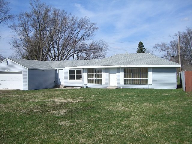 2114 Rivington Road Loves Park, IL 61111 - Photo 1 of 7 a front view of a house with a garden