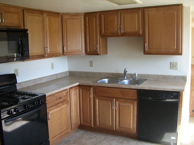 2114 Rivington Road Loves Park, IL 61111 - Photo 6 of 7 a kitchen with stainless steel appliances granite countertop a sink stove and cabinets