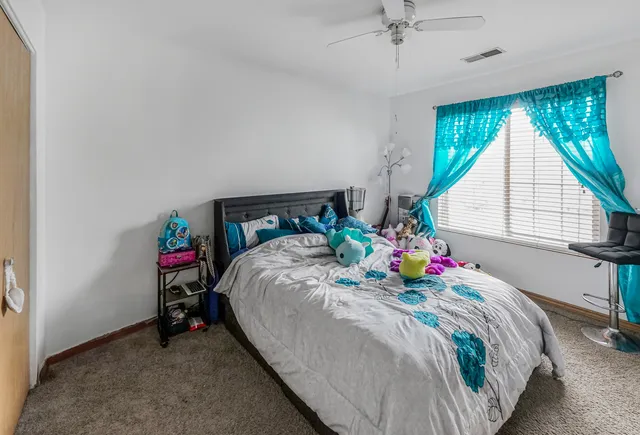 a bed sitting in a bedroom next to a window
