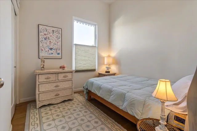 a bedroom with a bed and lamp