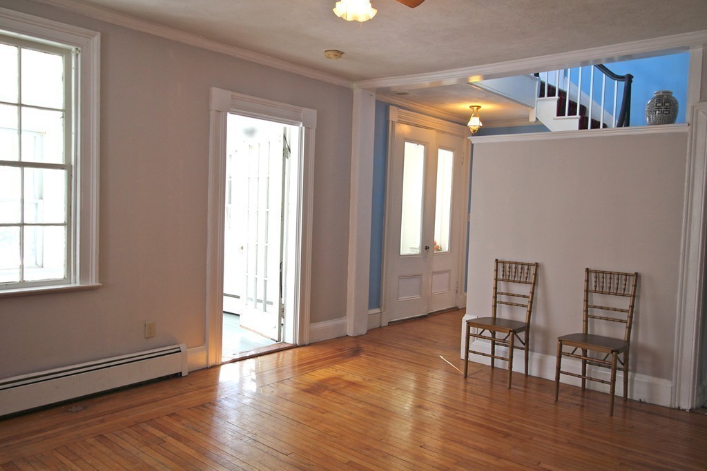 68 County Road, Unit 1 Ipswich, MA 01938 - Photo 11 of 22 an empty room with wooden floor and windows