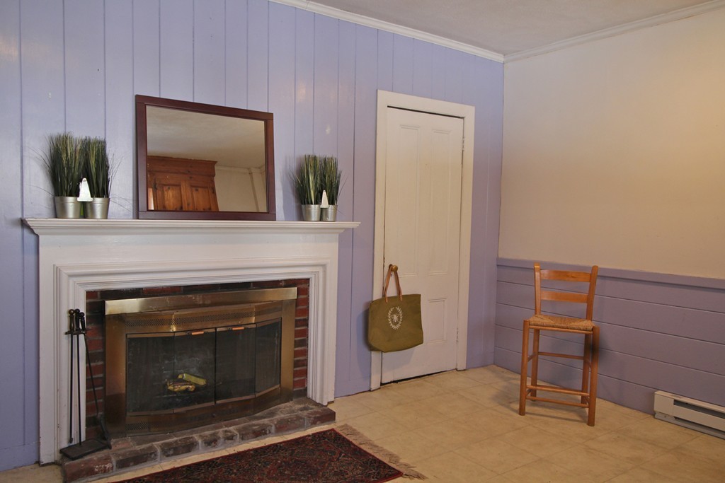 68 County Road, Unit 1 Ipswich, MA 01938 - Photo 14 of 22 a living room with furniture and a fireplace