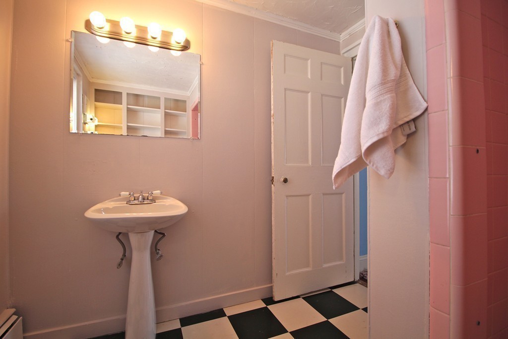 68 County Road, Unit 1 Ipswich, MA 01938 - Photo 19 of 22 a bathroom with a sink a mirror and a shower