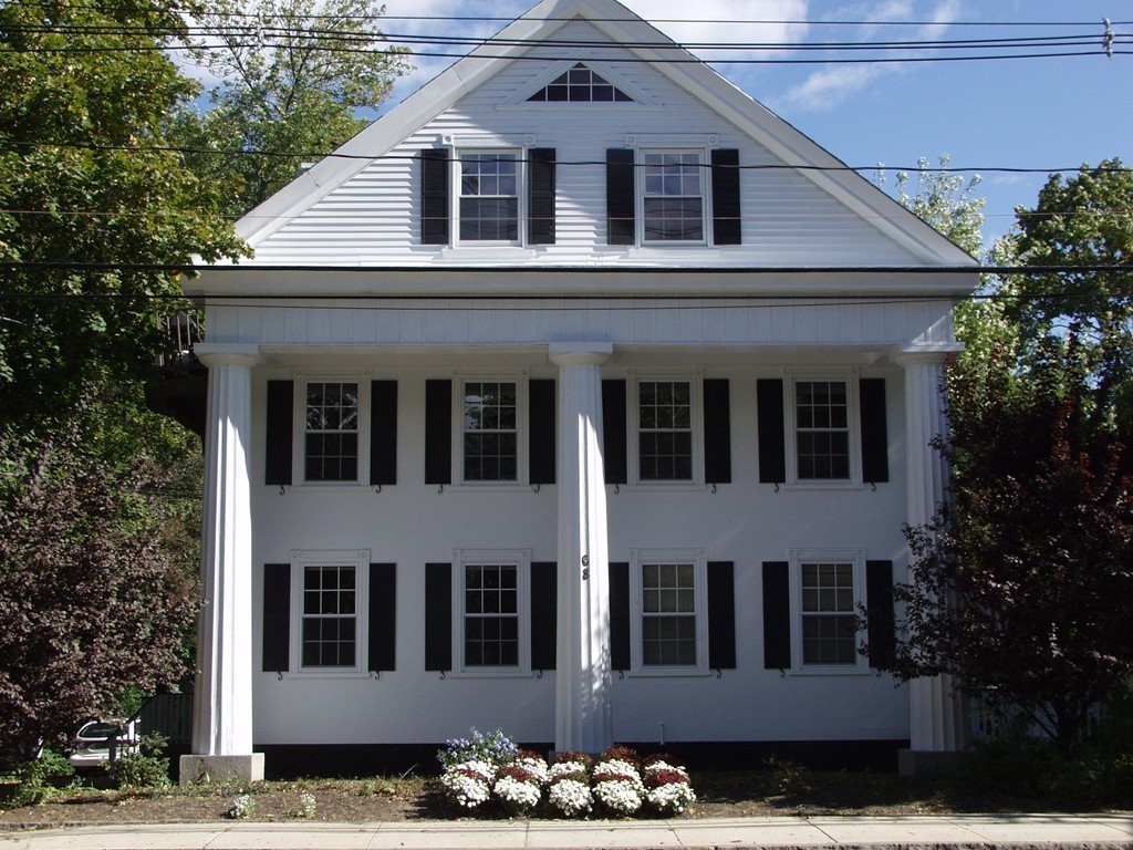68 County Road, Unit 1 Ipswich, MA 01938 - Photo 2 of 22 a front view of a house with a garden
