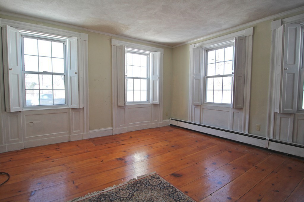 68 County Road, Unit 1 Ipswich, MA 01938 - Photo 8 of 22 an empty room with wooden floor and windows