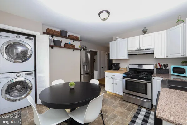 a kitchen with a stove a microwave and sink