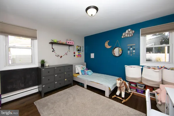 a bedroom with furniture and a window