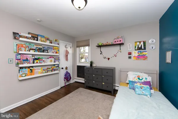 a bedroom with toys and a wooden floor