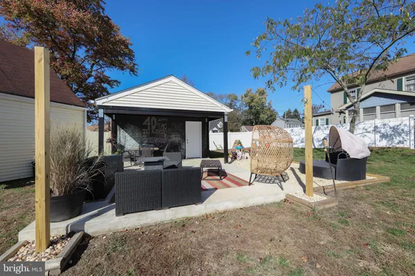 a view of a house with backyard porch and sitting area