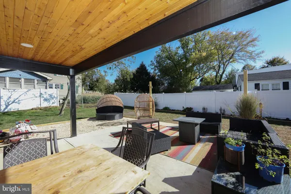 a outdoor space with a table and chairs