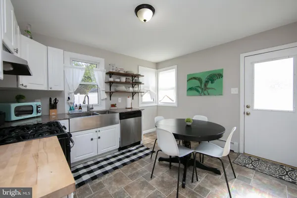a kitchen with granite countertop a sink and a stove top oven
