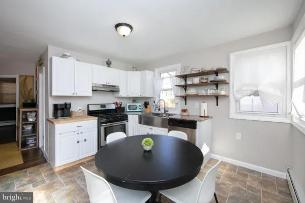 a kitchen with a sink a stove a refrigerator and cabinets