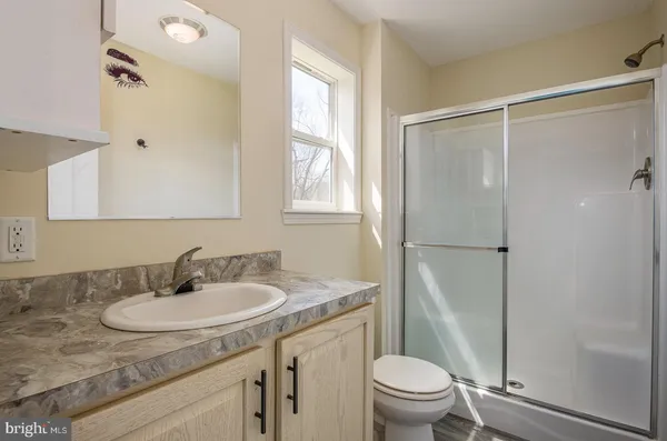 a view of a dry yard with wooden fence