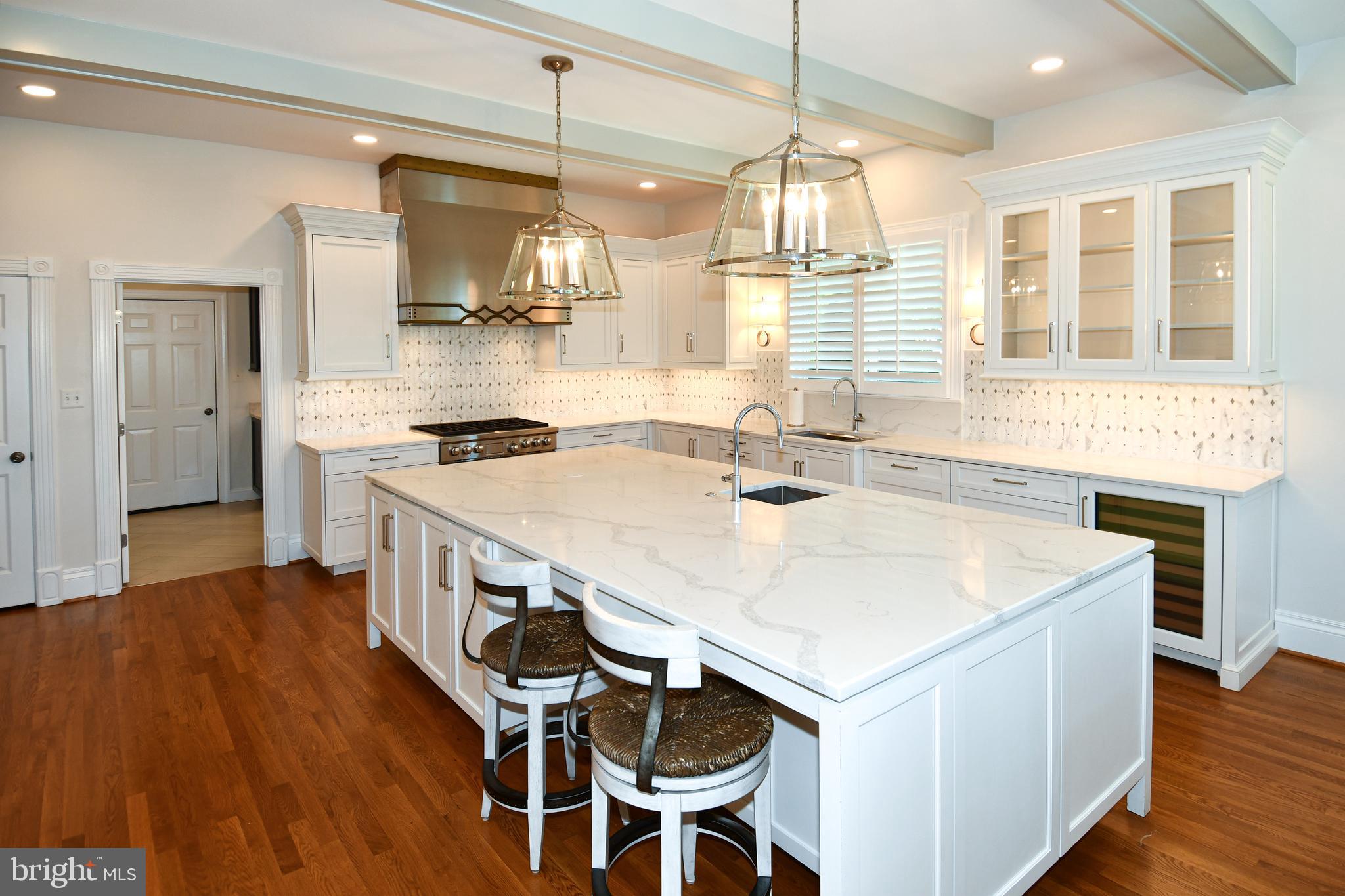7808 Southdown Road Alexandria, VA 22308 - Photo 39 of 99 a kitchen that has a sink a stove and chairs