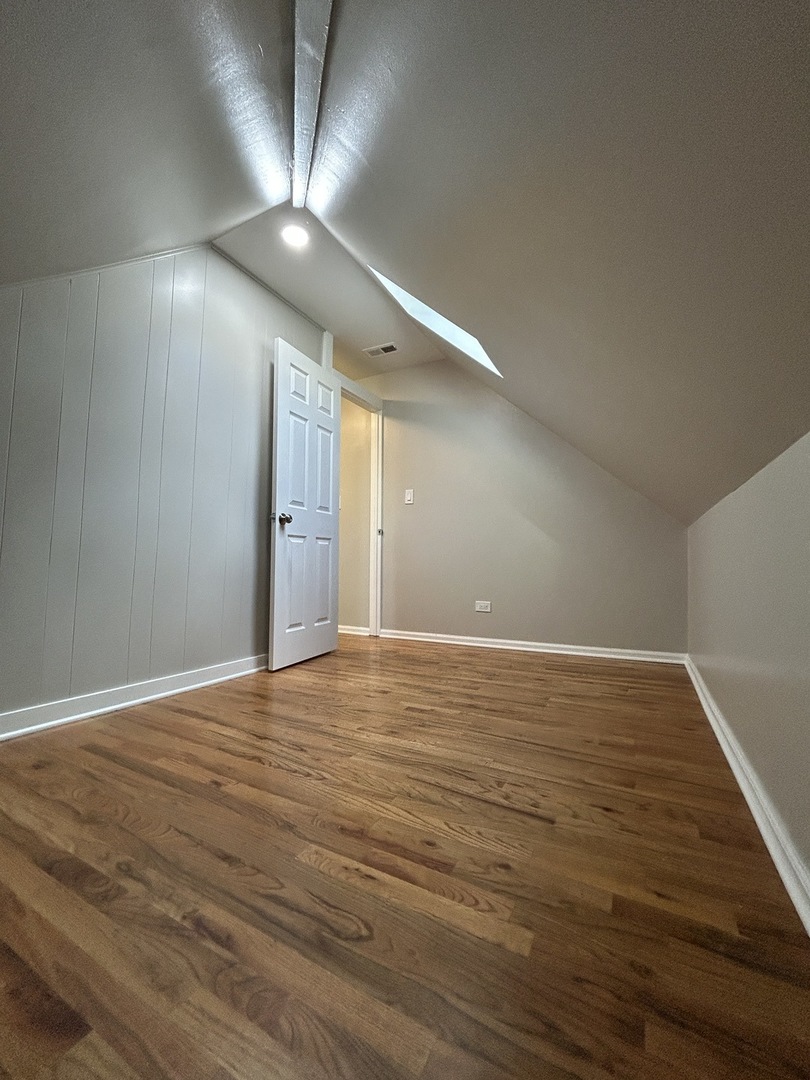 4834 North Ridgeway Avenue, Unit 3 Chicago, IL 60625 - Photo 12 of 12 a view of an empty room with wooden floor