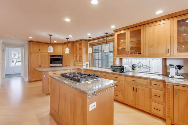a kitchen with stainless steel appliances granite countertop a stove and a sink