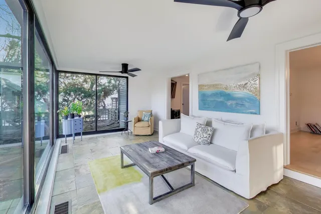 a living room with furniture and a floor to ceiling window